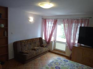 a living room with a couch and a window at PENSJONAT RELAX in Krynica Morska