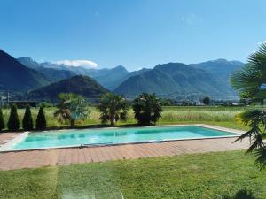 a swimming pool with mountains in the background at Apartments Volče in Tolmin
