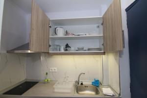 a kitchen with a sink and a counter top at Sea Breeze in Paleokastritsa