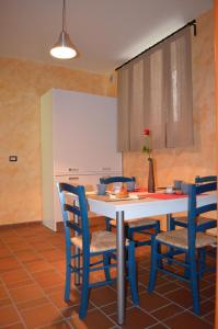 a kitchen with a table and blue chairs at B&B La casa di Giulietta in Castelmezzano