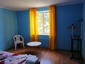 a bedroom with a bed and a table and a window at Tanie noclegi w Bieszczadach in Hoczew