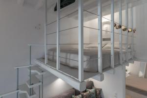 a white bunk bed in a white room at Aretis home in Plaka Milou