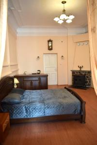 a bedroom with a bed and a clock on the wall at Stone Garden in Liepāja