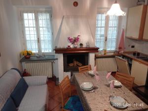 a living room with a table and a fireplace at EMY & LU CASA VACANZE CITTA' ALTA Centro Storico in Bergamo +36 photos