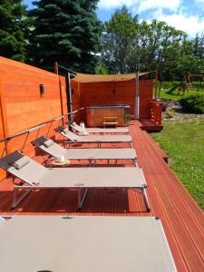 a group of lounge chairs sitting on a deck at Apartmány Brychovi in Červený Potok