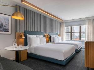 a hotel room with two beds and a table at 21c Museum Hotel Chicago in Chicago +114 photos