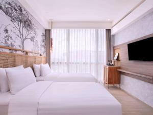 Postelja oz. postelje v sobi nastanitve Mercure Tangerang BSD City