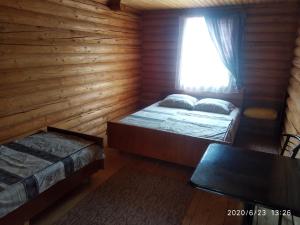 a bedroom with two beds and a window at Fiesta in Solotvyno