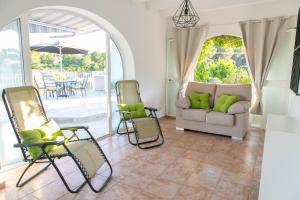 a living room with chairs and a couch at Villa Ana in Moraira