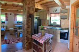 a kitchen with a table in the middle of a room at Domček u Fera in Zázrivá