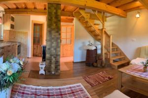 a kitchen with a spiral staircase in a house at Domček u Fera in Zázrivá