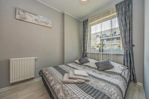 Posteľ alebo postele v izbe v ubytovaní Apartament LUX