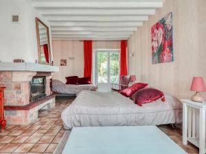 a living room with two beds and a fireplace at Cozy Farm House in Boncourt with Barbeque in Sainte-Preuve