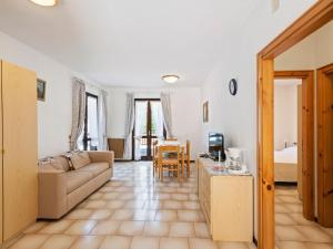 a living room with a couch and a table at Apartment in Ledro by Lake & Dolomites in Ledro