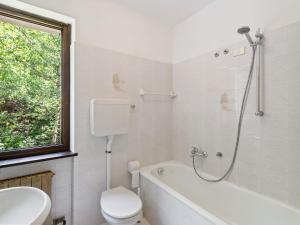 a bathroom with a tub and a toilet and a sink at Apartment in Ledro by Lake & Dolomites in Ledro +17 photos