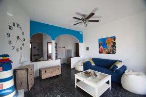 salon z niebieską kanapą i wentylatorem sufitowym w obiekcie Apartment Lerici w mieście San Terenzo