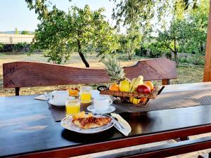 a table with a plate of food and a basket of fruit at Village House Fafarinka - close to Krka National Park in Konjevrate