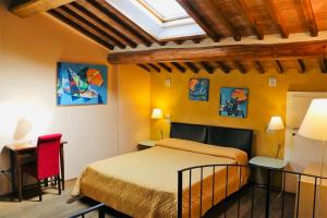 a bedroom with a bed and a skylight at Il Corso in Montepulciano