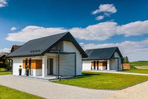 a rendering of a house with a black roof w obiekcie APARTAMENTY LAS Zator w Zatorze
