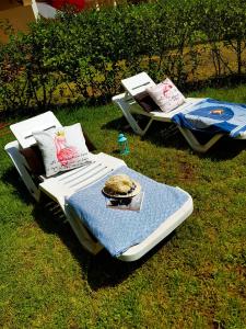 two beds sitting on the grass in the yard at FamilyConfort Saidia in Saïdia