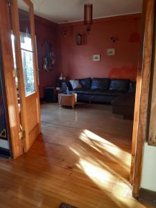 a living room filled with furniture and a window at Airesbuenos Hostel y Permacultura in Valdivia