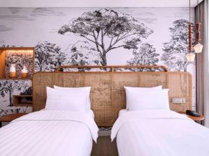Postelja oz. postelje v sobi nastanitve Mercure Tangerang BSD City