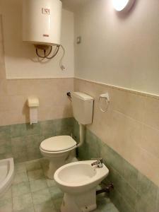 a bathroom with a toilet and a sink at Appartamento Rosati in Oliveri