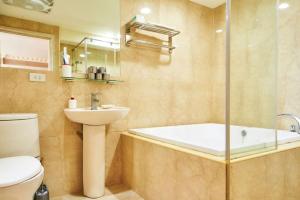 a bathroom with a tub and a sink and a toilet at Sea Keelung 61 in Keelung