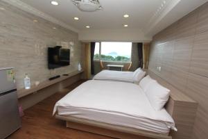 A bed or beds in a room at Sea Keelung 61