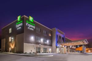 a hospital building with neon signs at night at Holiday Inn Express & Suites - Van Horn by IHG in Van Horn