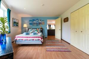 een slaapkamer met een bed en een tapijt bij Island Breeze - Round House with BBQ - Wooden Hot Tub - Beach in Onna