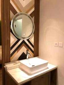
a mirror on a wall in a room at Jambuluwuk Convention Hall & Resort Batu in Batu
