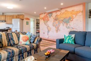 a living room with two couches and a map on the wall at Island Breeze - Round House with BBQ - Wooden Hot Tub - Beach in Onna +23 photos