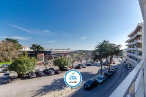 - une vue sur une rue avec des voitures garées dans un parking dans l'établissement Hotel Alvorada, à Estoril