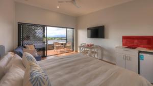 a bedroom with a bed and a view of a balcony at Atherton Motel in Atherton