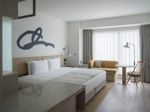 Postel nebo postele na pokoji v ubytování Zentis Osaka