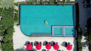an overhead view of a swimming pool with tables and chairs at Samui Boat Lagoon in Choeng Mon Beach