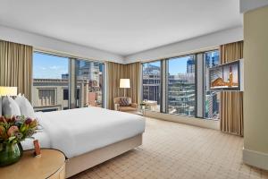 a hotel room with a large window overlooking the ocean at The Fullerton Hotel Sydney in Sydney