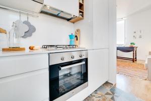 eine Küche mit weißen Schränken und einem Backofen in der Unterkunft Beautiful designer flat close to Pantheon in Rom
