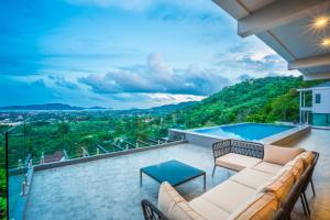 a view from the roof of a house with a couch at Nakara Hill Phuket in Chalong 