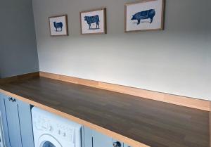 a laundry room with a washer and dryer at Rowley Farm Holidays in Worcester