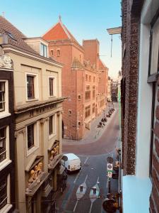 a view from a window of a city street with a car at Amsterdam Central Guest House in Amsterdam