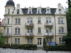 a large white building with a dome on top at Villa Dagmar in Luhačovice