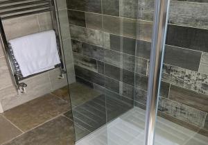 a shower with a glass door in a bathroom at Rowley Farm Holidays in Worcester +44 photos