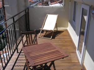 a wooden bench sitting on top of a patio at Hôtel Jaures in Toulon