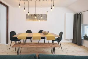 a dining room with a wooden table and chairs at *80 m2 Stylish Apt* Netflix * Kitchen* Nespresso* in Wuppertal