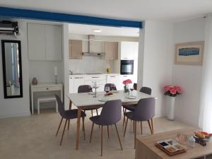a kitchen and dining room with a table and chairs at Vila Hrvatska in Ražanj