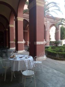 a table and chairs in a courtyard with a building at Casa S. Giuseppe di Cluny in Rome