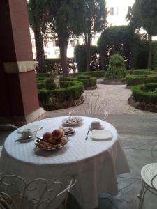 a table with plates of food on it in a garden at Casa S. Giuseppe di Cluny in Rome