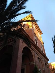a building with a clock tower on top of it at Casa S. Giuseppe di Cluny in Rome